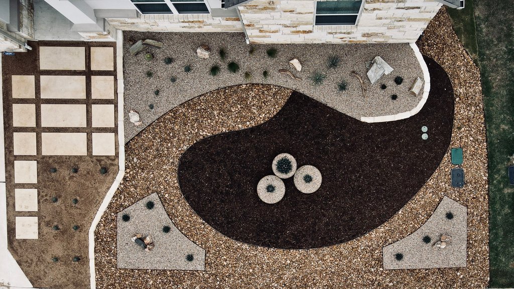 Aerial view of a paver layout set into gravel and mulch at a Spicewood, Austin home