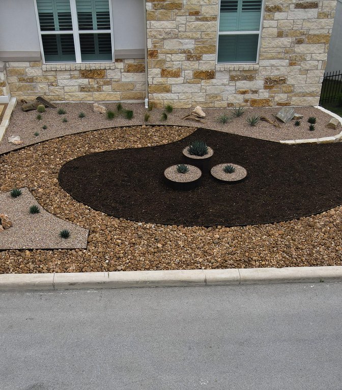 Completed Spicewood xeriscape with gravel, mulch, and planters built from the design