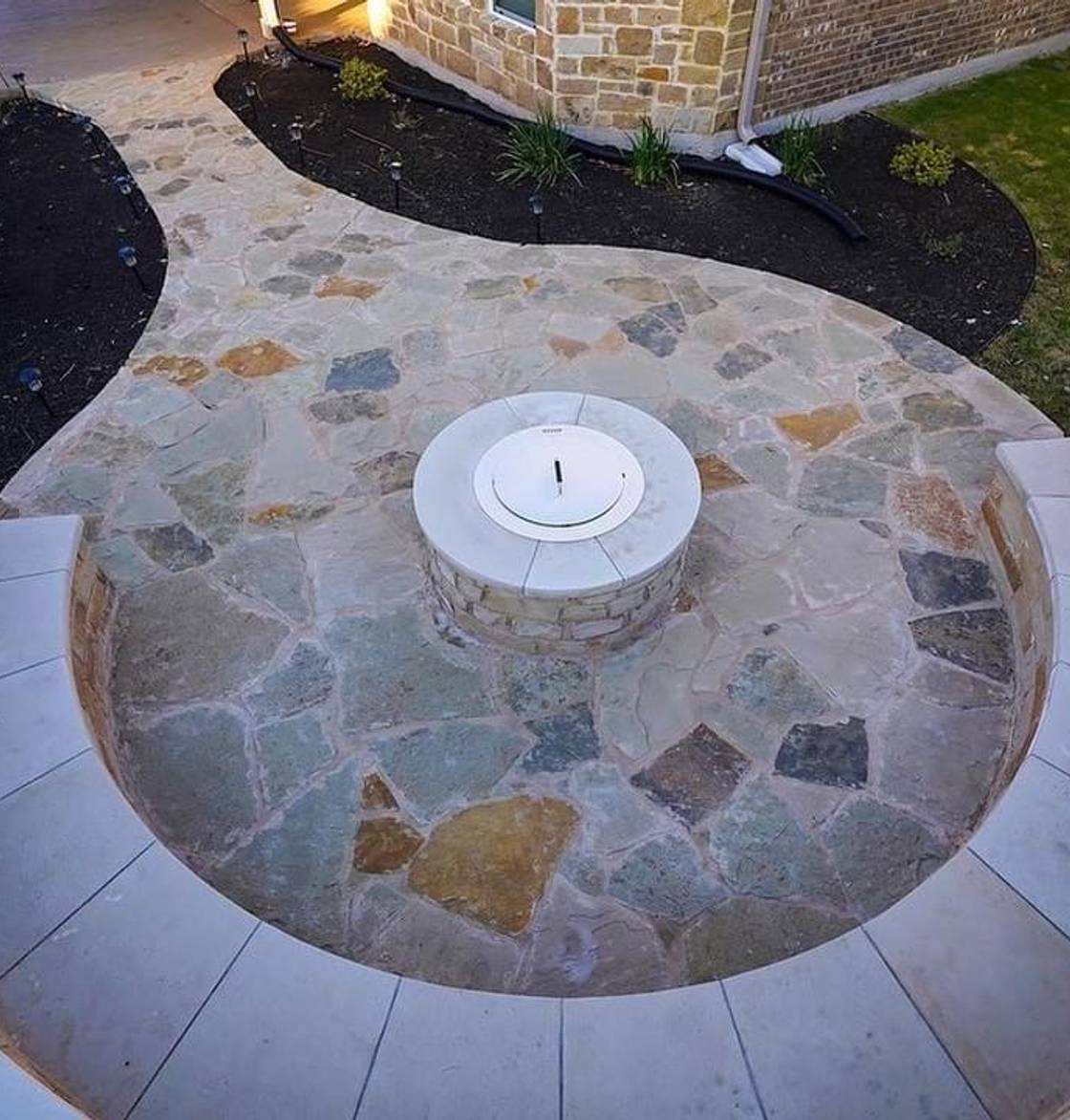 Steiner Ranch home with stone walkway, native plantings, and landscape lighting