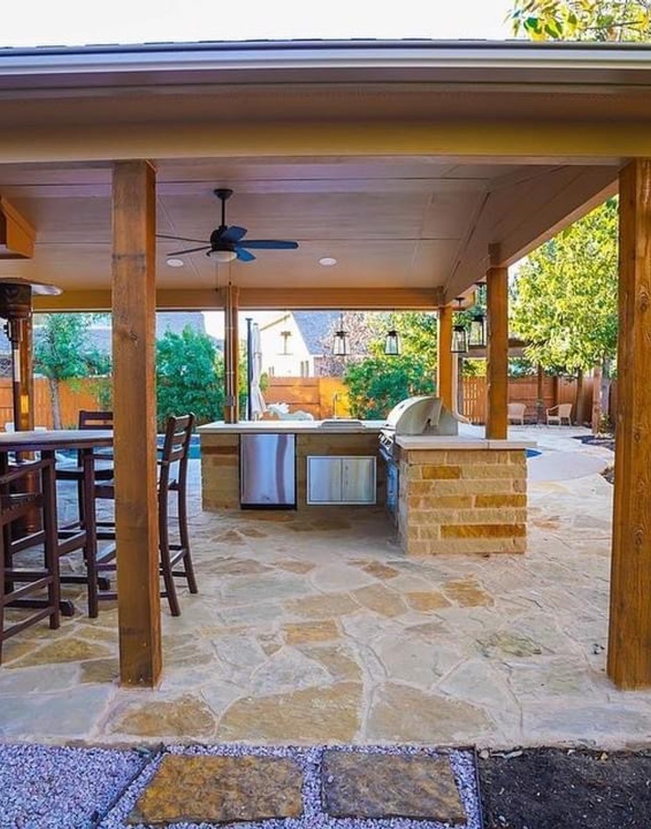 Pergola and outdoor kitchen detail with hanging lantern pendants