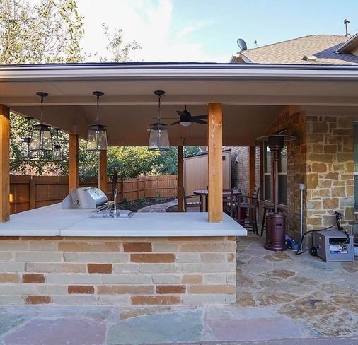 Pergola, outdoor kitchen, and flagstone patio at a Steiner Ranch design-build project