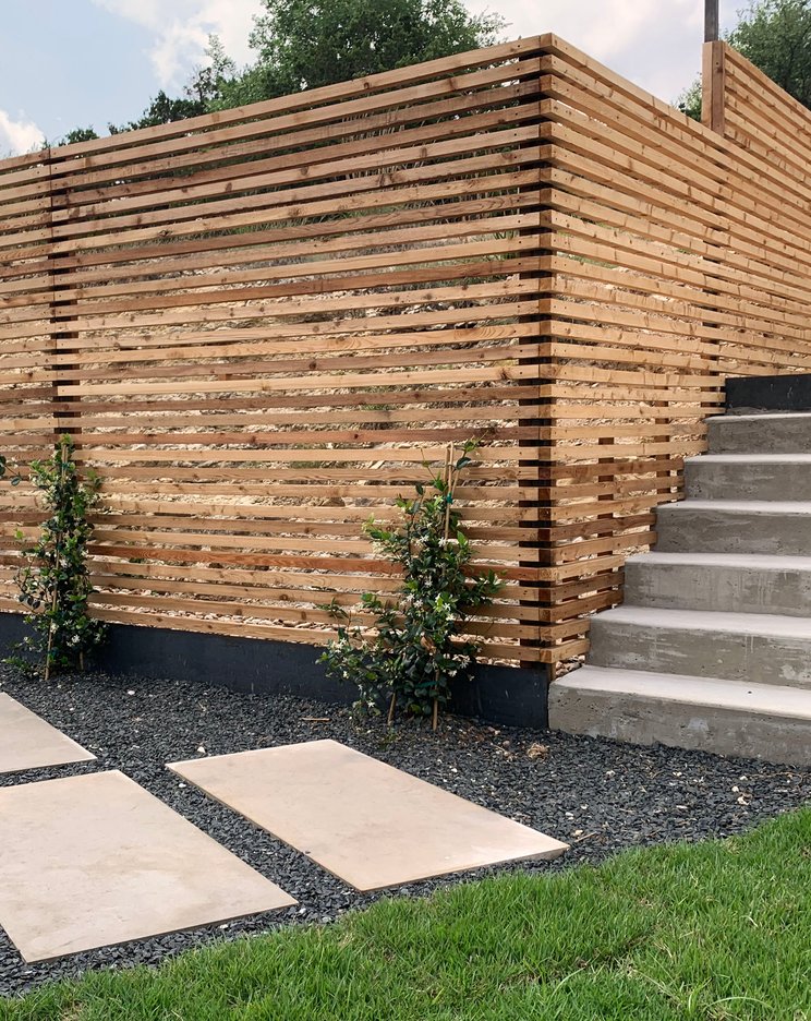 Custom mixed-material fence with cedar slats on a Westlake Hills terrace
