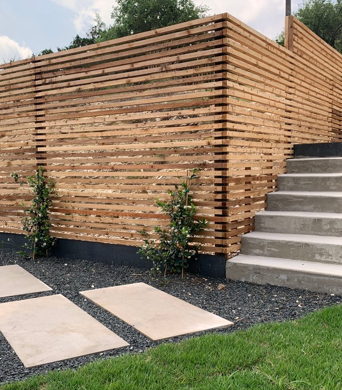 Clean slat privacy fence on a low-maintenance Westlake Hills lot