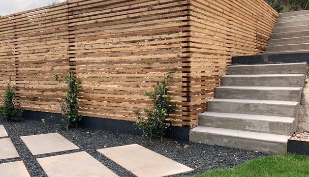 Clean low-maintenance slat fence on a modern Westlake Hills home