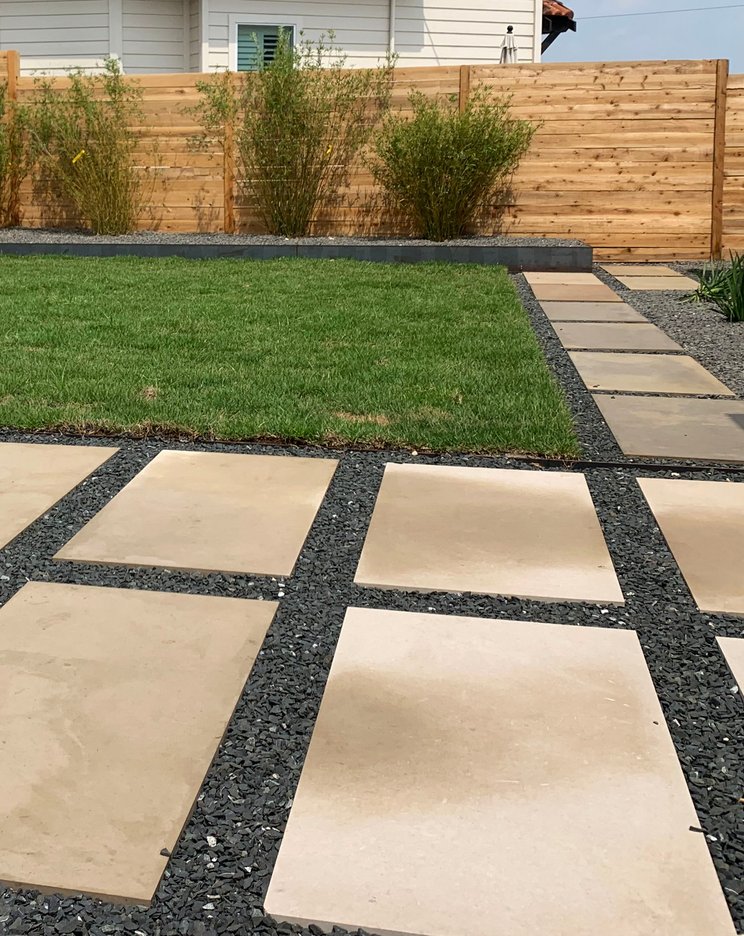 Healthy sod, gravel, and planting beds on a modern Westlake Hills terrace watered by zone