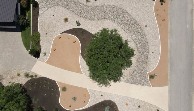 Xeriscape in the Austin Hill Country with crushed granite, river rock, and native plantings